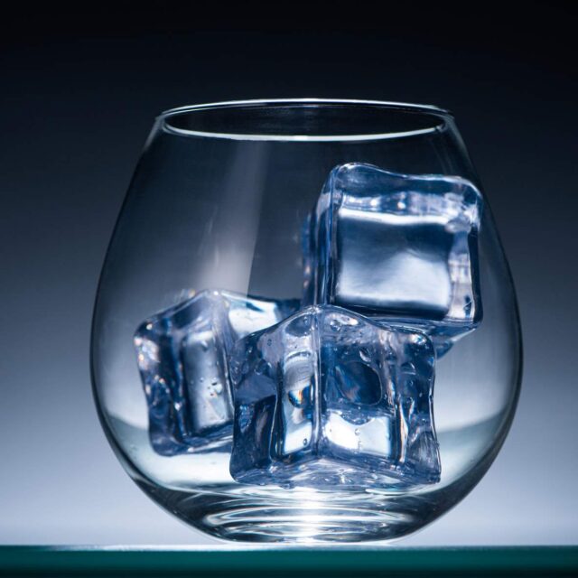 transparent-glass-with-ice-cubes-in-dark-with-blue-2023-11-27-04-50-08-utc